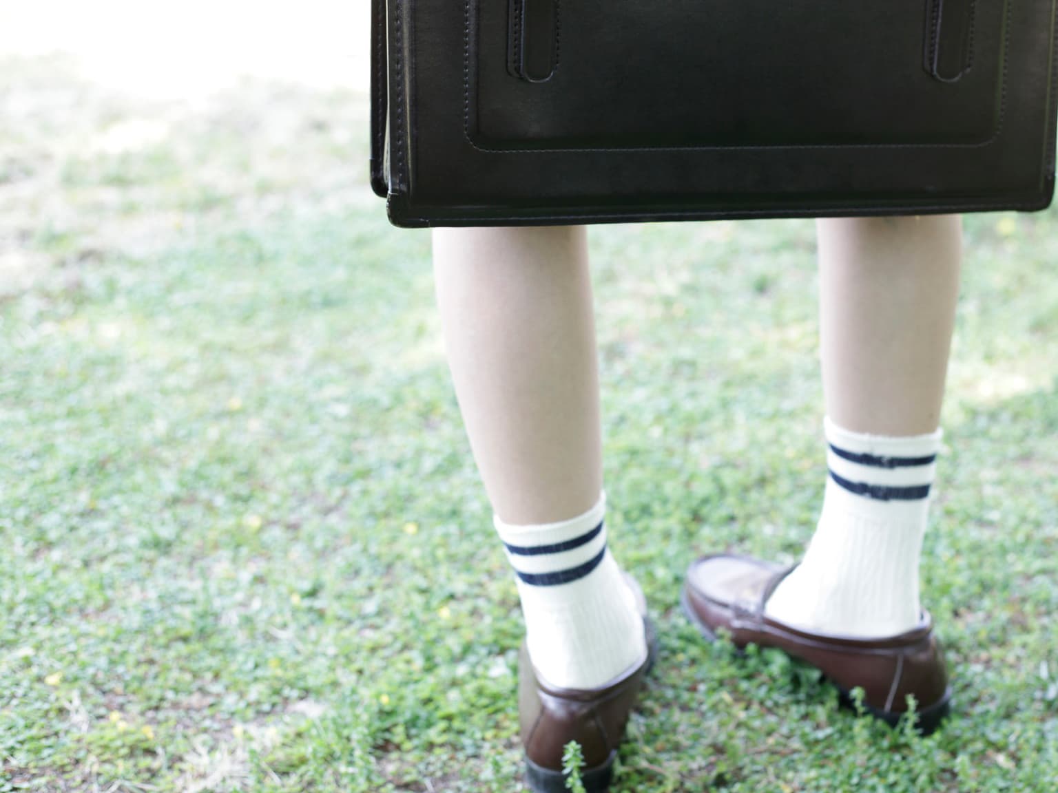 Discarded cotton sock beside a bare sole, intimate detail shot with warm, inviting tones